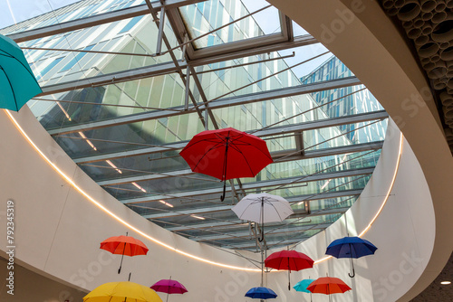 Installation of colorful umbrellas under the roof of the shopping center