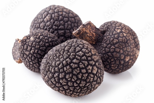 Isolated black truffles on white backdrop