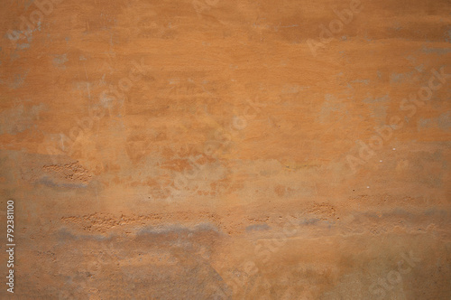 Texture of old wall covered with yellow stucco
