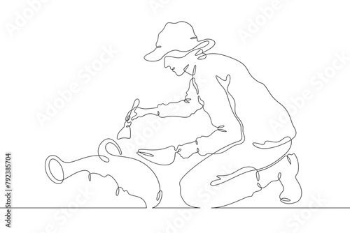 Archaeologist at an excavation. An archaeologist with tools in hand conducts historical research. Historian. Archeology. One continuous line . Line art. Minimal single line.White background. One line 