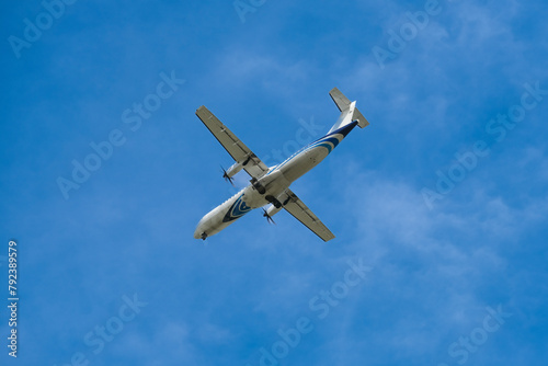 Airplane flying in the sky preparing to land at the airport. Air travel and traveling abroad