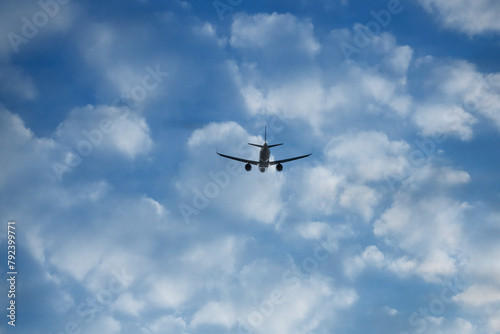 Commercial jet flying on white clouds background. back, rear view of plane, Airplane fly on blue sky backdrop. take off.