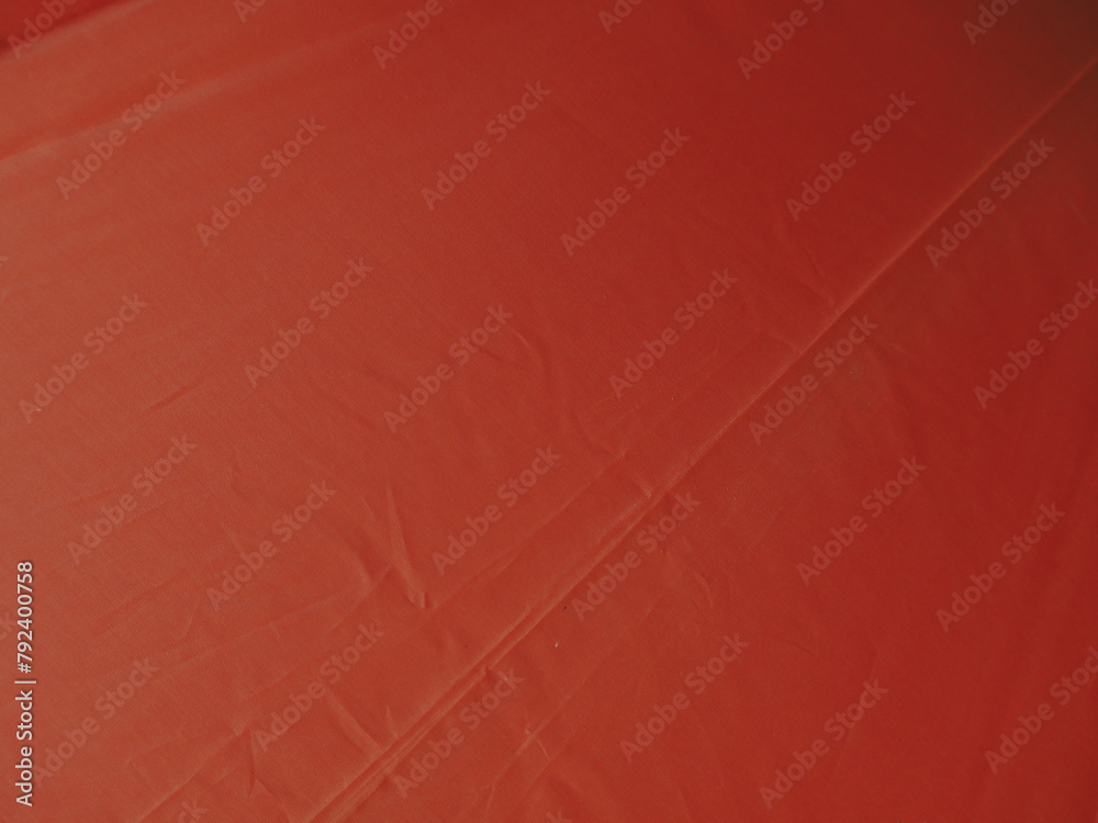 Fototapeta premium Bright orange umbrella texture for a background about the rainy season or summer.