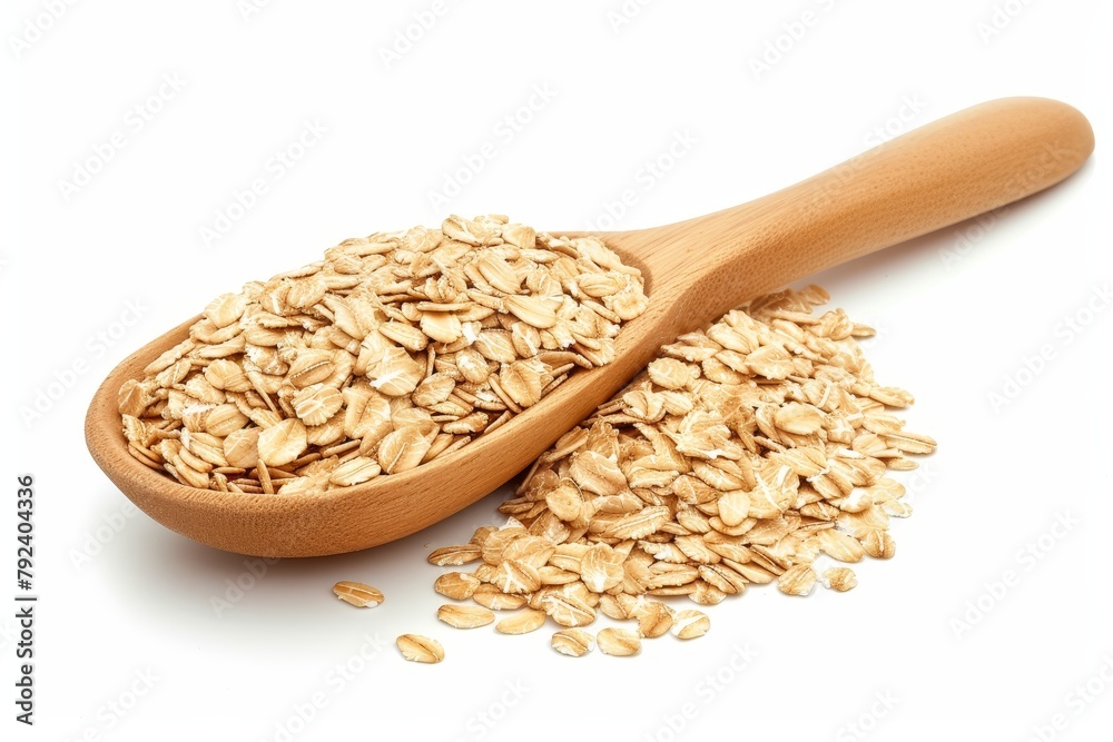 Rolled oats piled with spoon on white background Rolled oats piled with spoon on white background