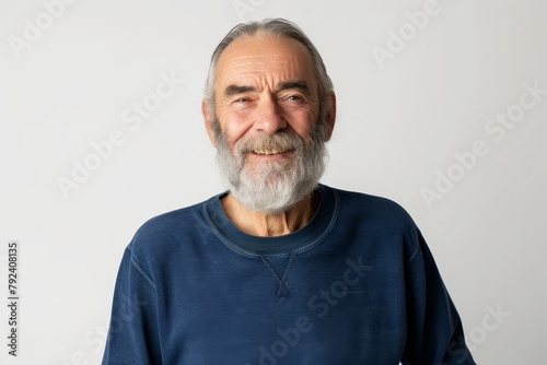 Smiling old man with beard and gray hair in blue sweatshirt stands alone looks at camera headshot © LimeSky