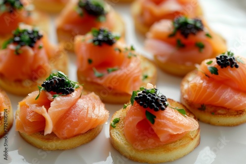 Smoked salmon bites topped with lumpfish caviar photo