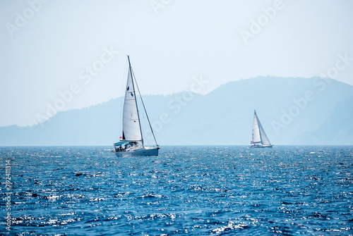 Sailboat in the Sea over Beautiful Mountains Background