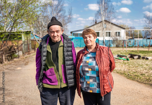Portrait of 75 years old grandparents in russian village together