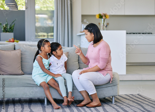 Photos Mother, pointing and angry children in home, discipline and communication or strict parent in family house