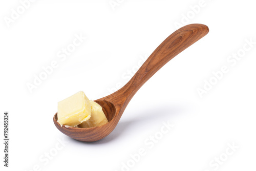 Butter in wooden spoon isolated on white background with clipping path.