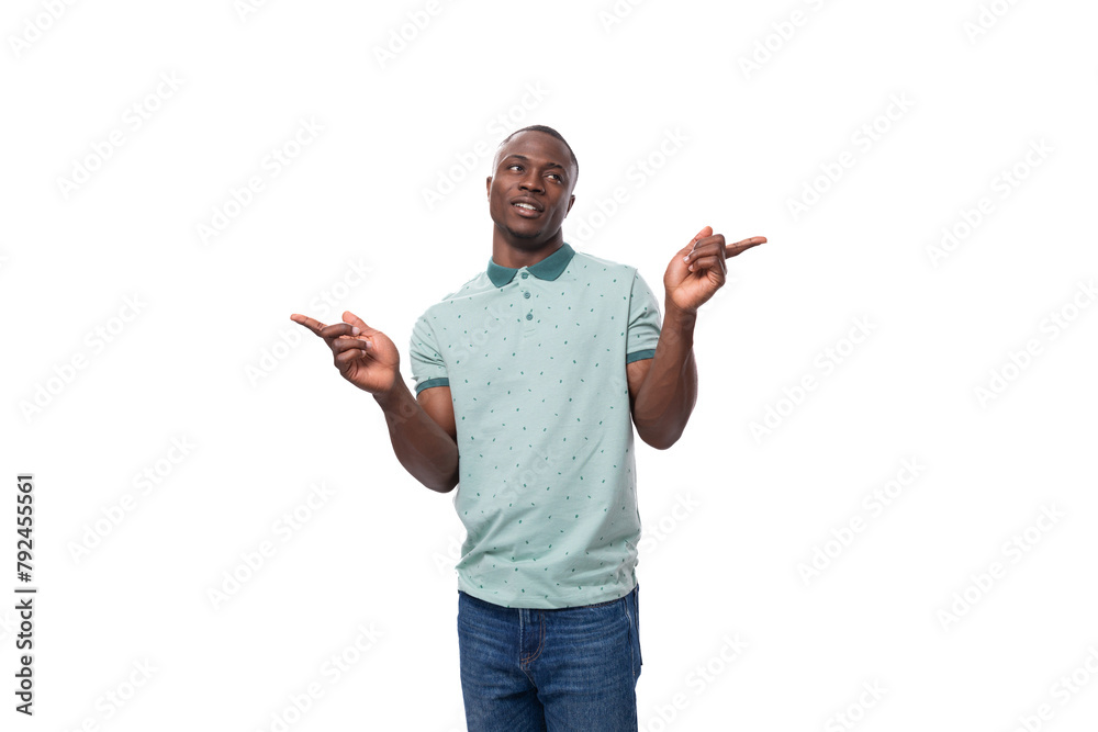 young short-haired american man dressed in a summer t-shirt points his hands to the sides to report the news young short-haired american man dressed in a summer t-shirt points his hands to the sides to report the news