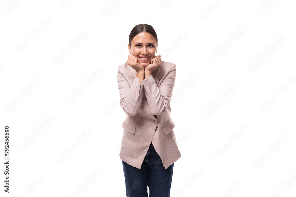 joyful energetic young caucasian woman with black hair gathered in a ponytail is dressed in a beige jacket is experiencing positive emotions joyful energetic young caucasian woman with black hair gathered in a ponytail is dressed in a beige jacket is experiencing positive emotions