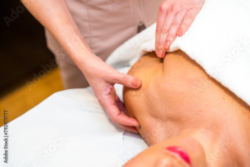 Masseur identifying the point of pain in patient