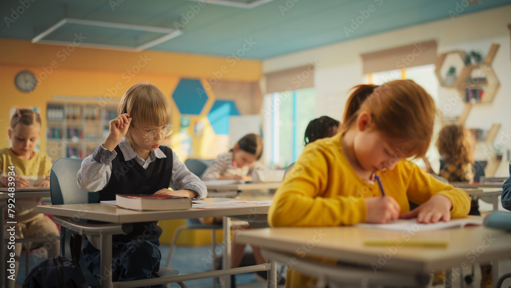 Primary School Children Working on a Test Assignment in Class: Smart Diverse Kids Focused on Exercises, Thinking, Searching for a Correct Solution. Schoolchildren Getting Modern Education Primary School Children Working on a Test Assignment in Class: Smart Diverse Kids Focused on Exercises, Thinking, Searching for a Correct Solution. Schoolchildren Getting Modern Education