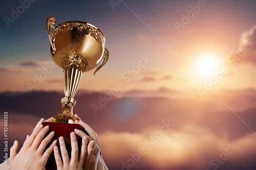 Success of teamwork, team holding trophy © BillionPhotos.com
