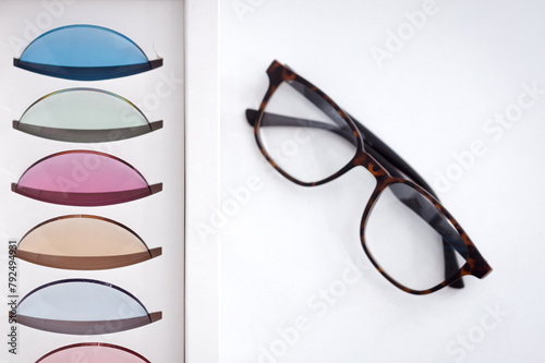 Vision glasses frame near many colorful ophthalmological lenses for eye protection © bymandesigns