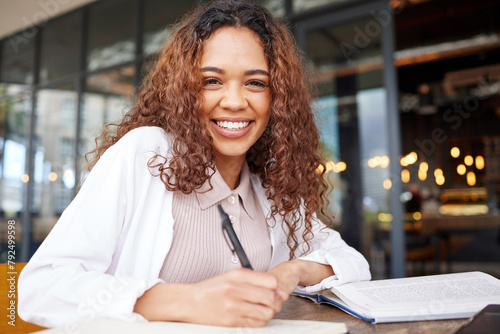 Student, woman and study with smile for exams preparation or presentation with textbook in cafe. Portrait, college learner and happy or satisfied in restaurant with notes for revision and test
