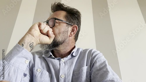 One man working on laptop with stress and anxiety alone. Camera webcamera view. Professional freeance with glasses using computer keyboard pov view. Doubts and frustration concept business lifestyle photo