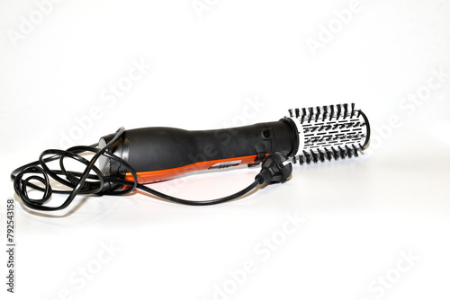 Hair dryer brush for curling hair on a white background.