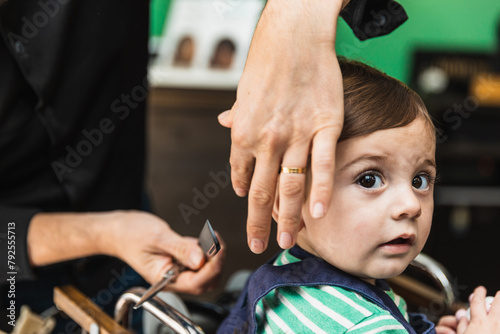 Little boy's first haircut at barbershop