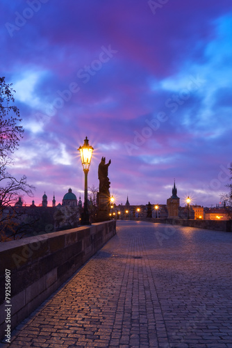 Charles Bridge at dawn, silhouette of figures of saint sculptures red dramatic sky photo