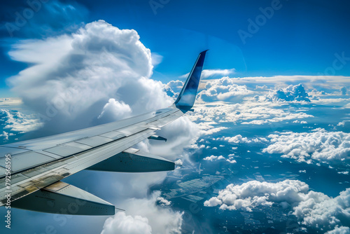 A plane is flying through a cloudy sky. The clouds are white and fluffy, and the sky is blue. The plane is in the middle of the clouds, and it looks like it's flying through a dreamy