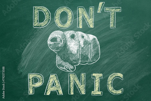 Closeup of a human hand pointing at you with lettering DONT PANIC. Illustration drawn in chalk on a greenboard.