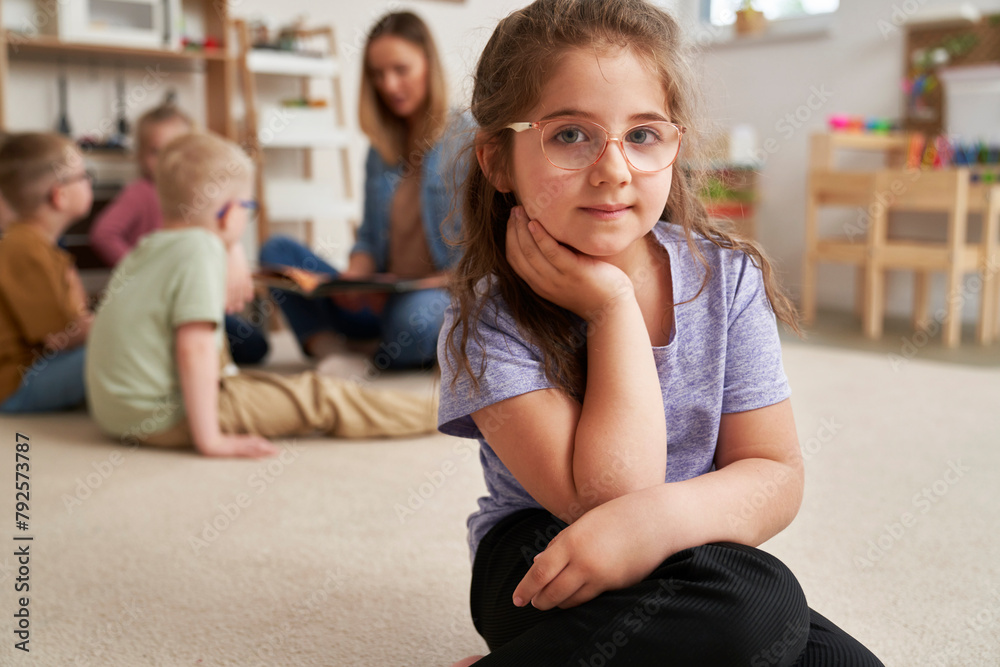 Portrait of preschool girl and children in the background Portrait of preschool girl and children in the background