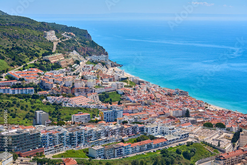 aerial view over city of Sesimbra with atlantic ocean in background photo