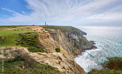 nice active woman cycling with her electric mountain bike on the cliffs of Cabo Espichel near Sesimbra, Portugal