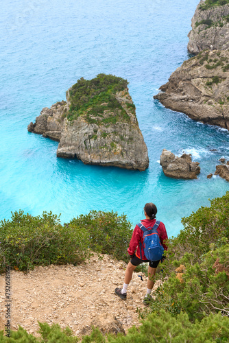 Woman walking at the stunning beach of the Praia do Ribeiro do Cac´valo, maybe the must beautiful bay in Portugal near Sesimbra
 photo