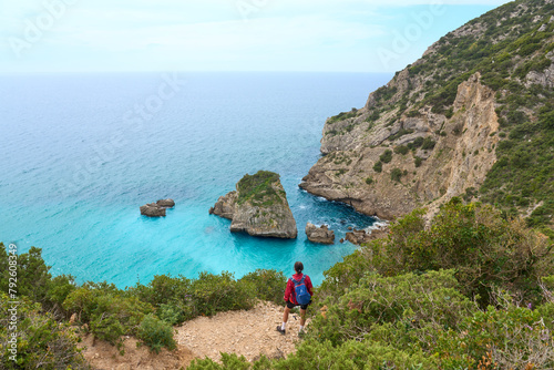 Woman walking at the stunning beach of the Praia do Ribeiro do Cac´valo, maybe the must beautiful bay in Portugal near Sesimbra
 photo