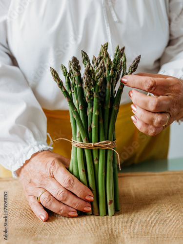 Close up of elderly woman's hands with asparagus © JRP Studio