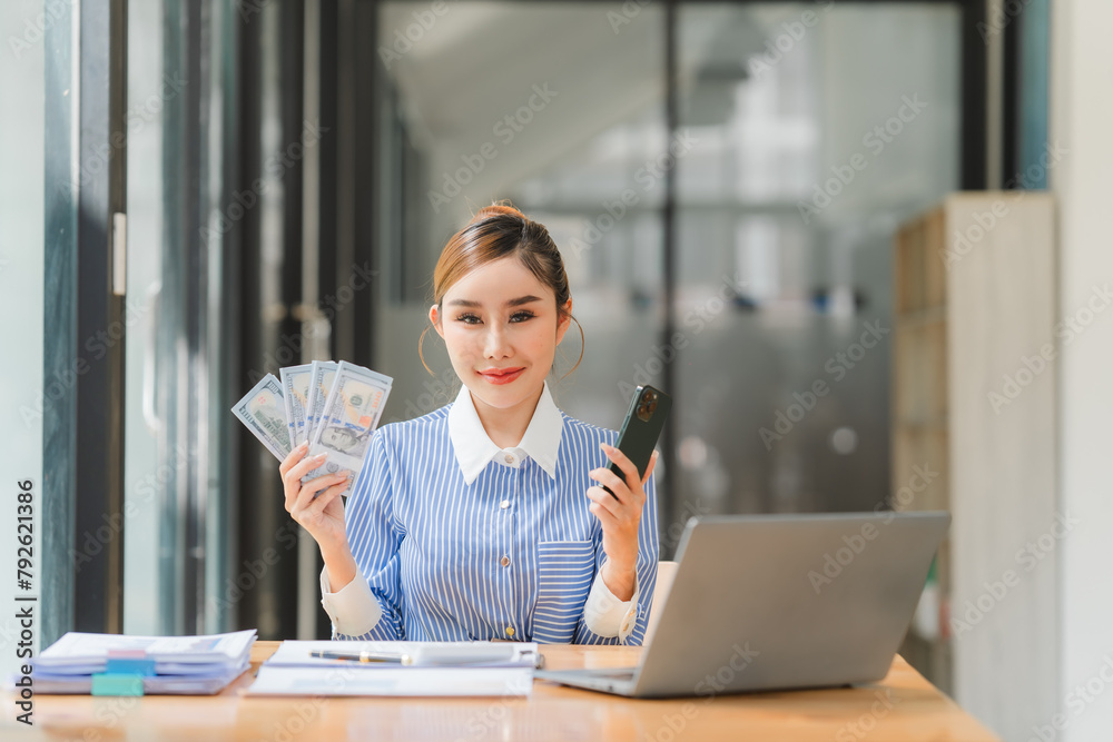 A business owner is counting money and making notes in a financial book, The financier is verifying the income received from the client's investment, A business owner is counting money and making notes in a financial book, The financier is verifying the income received from the client's investment,