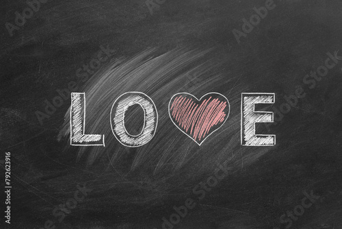 LOVE word with heart shape hand drawn on blackboard. Valentines day, love, compassion concept.