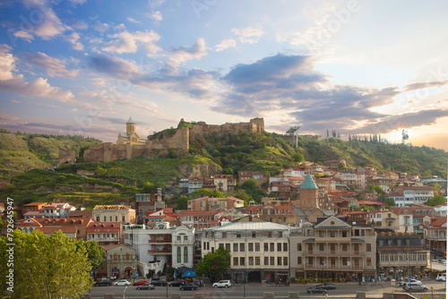 Beautiful landscape of Tbilisi on the background of blue cloudy sky and green mountains