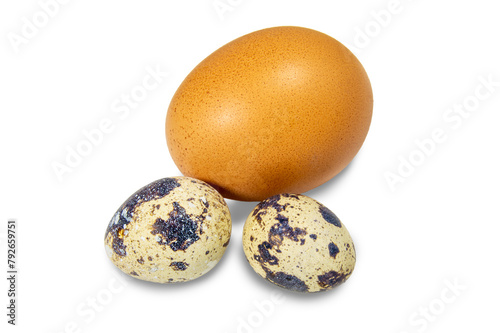 Three eggs are on a white background. The eggs are sitting on top of each other. Chicken egg and two quail eggs
