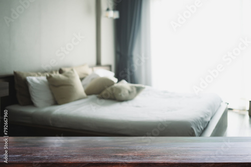 Empty wooden table top and blurred cozy bedroom interior. For your design content or product