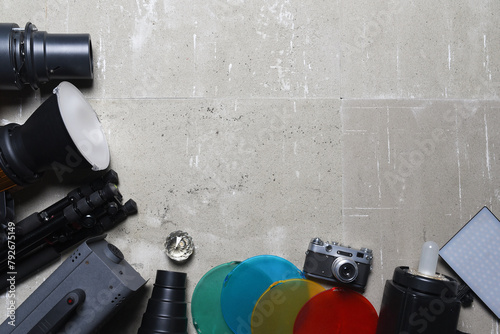 Photo studio equipment concept top view background with copy space. Photostudio led constant light sources and different light modifiers on the wooden table background. photo