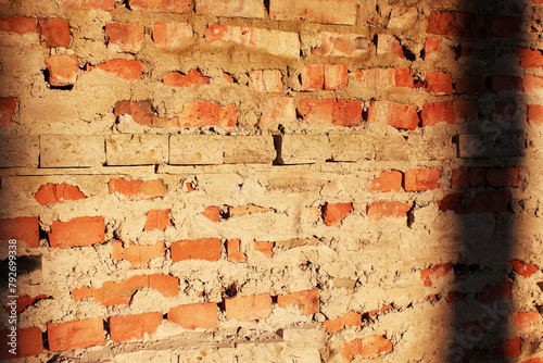 Vintage red brick wall and cement wall, side view with copy space. Selective focus. The background texture is old. Grunge urban background. Grunge cracked surface texture. Red brick wall. Dirty old 