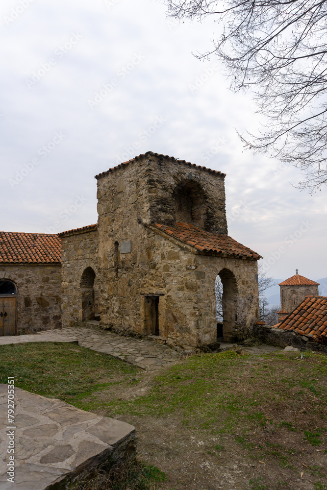 Buildings and churches of Nekresi monastery, Georgia. Orange tiles, stone walls and paths