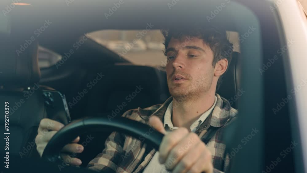 Sad Caucasian man auto driver inside car on parking lot displeased frustrated male businessman using mobile phone read bad news smartphone message upset anxious stressed guy driving travel in city
