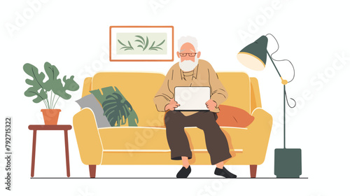 Grandfather on comfortable couch and using laptop