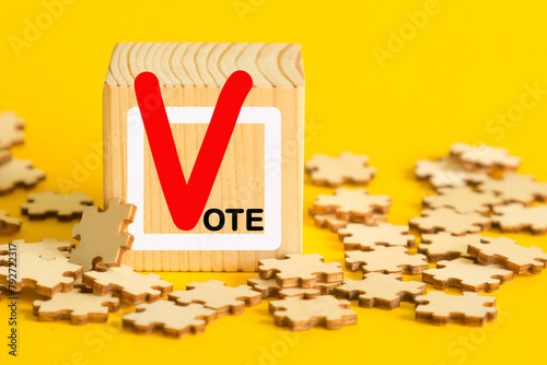 Election vote concept.Vote word with checkmark symbol on wooden cube blocks. Voting sign symbols. Elections and poll icons.