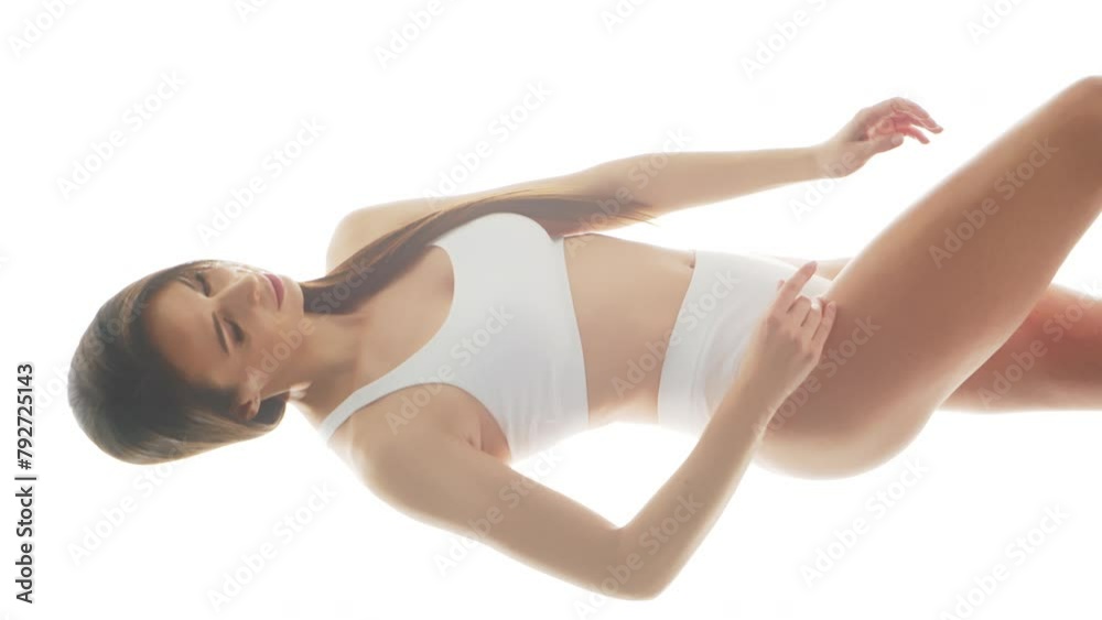 Beautiful woman in white underwear over isolated white background. Vertical studio video of healthy young girl in swimsuit. Health and skin care, wellness, dieting and cosmetics concept. Beautiful woman in white underwear over isolated white background. Vertical studio video of healthy young girl in swimsuit. Health and skin care, wellness, dieting and cosmetics concept.