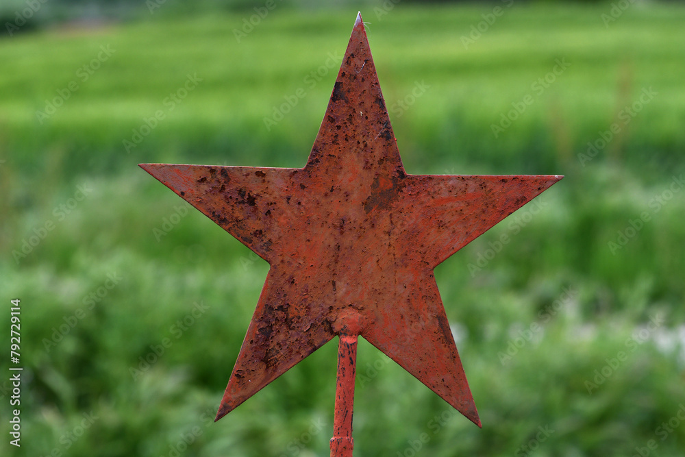 Memorial rusty star for the fallen soldiers, isolated on verdant reverence. Eternal Tribute .Green background. Memorial rusty star for the fallen soldiers, isolated on verdant reverence. Eternal Tribute .Green background.