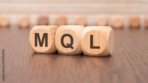 word mql - marketing qualified lead - is written on wooden cubes photo