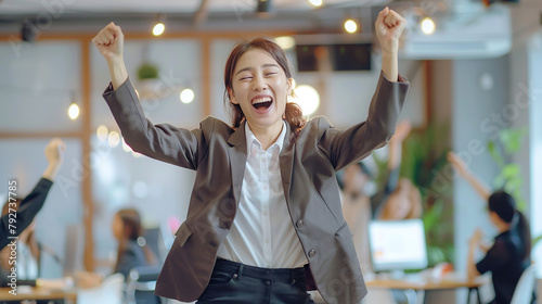 Happy asian businesswoman dancing in the office. 