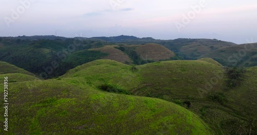 Bright Green Terrain Of Teletubbies Hill At Sunset On Nusa Penida Island In Bali, Indonesia. Aerial Shot photo
