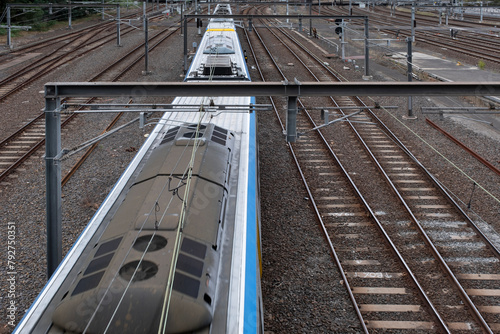 Yellow-blue Metro train, top view. Public transport and traffic in Melbourne's CBD (Central Business District), Victoria, Australia. Metro Melbourne is the largest suburban rail network in Australia
